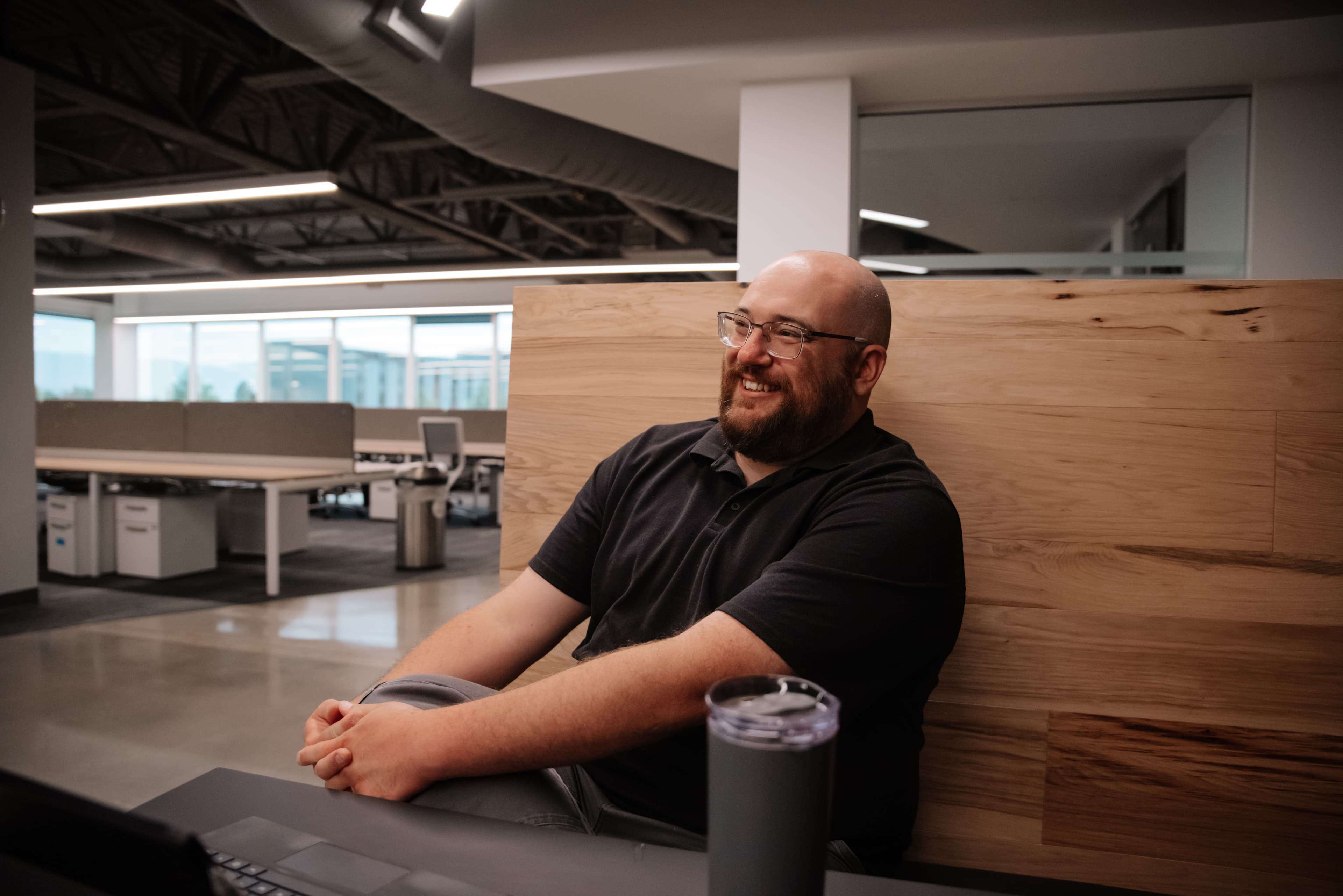 Joe sitting in a booth smiling.